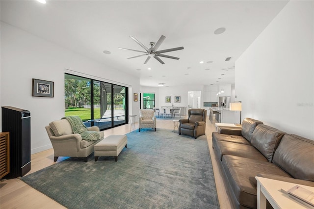 living room with hardwood / wood-style flooring and ceiling fan