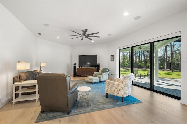 living room featuring ceiling fan and light wood-type flooring