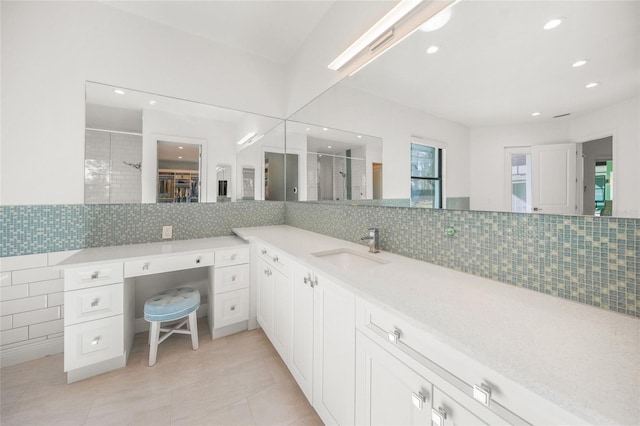 bathroom with tile patterned flooring, vanity, an enclosed shower, and tasteful backsplash