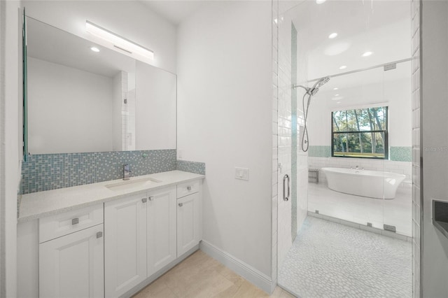 bathroom featuring tile patterned flooring, vanity, and plus walk in shower