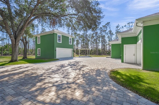 view of side of home featuring a lawn and a garage