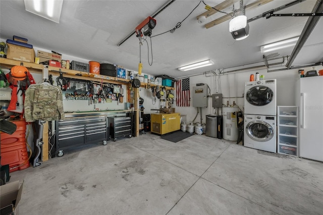 garage with a workshop area, electric water heater, a garage door opener, stacked washer and clothes dryer, and white fridge