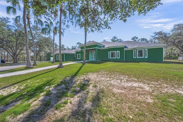 ranch-style home featuring a front lawn and french doors