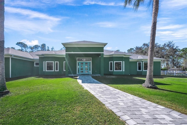 view of front facade with french doors and a front lawn