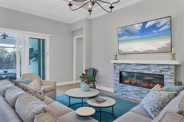 living room with hardwood / wood-style flooring, a stone fireplace, and crown molding