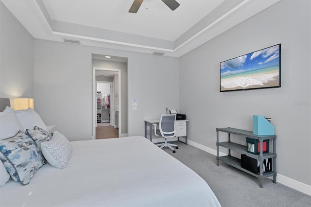 8089 Sandstar Way, Sarasota, FL 34240 - bedroom with a tray ceiling, carpet, and a ceiling fan