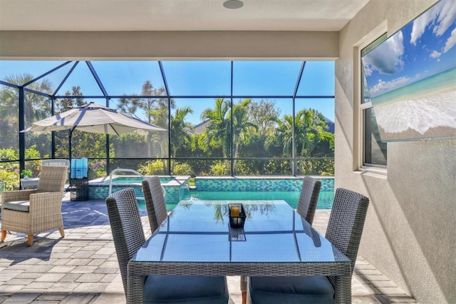 view of patio / terrace with a pool with hot tub and glass enclosure