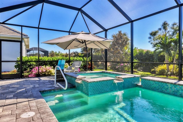 view of swimming pool featuring an in ground hot tub, pool water feature, glass enclosure, and a patio area