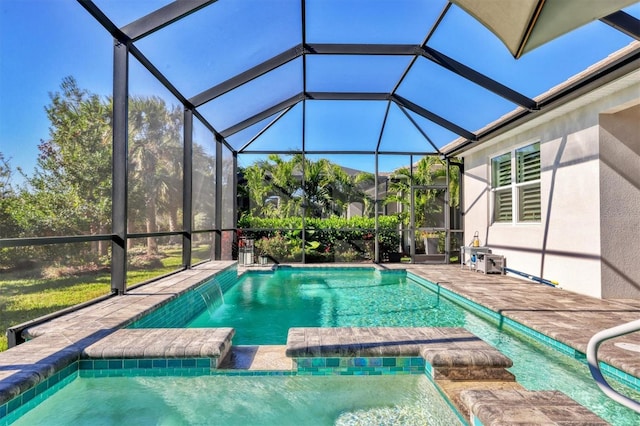 view of swimming pool featuring a patio area, pool water feature, and glass enclosure