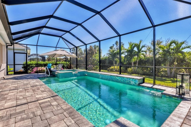 view of pool with a lanai, an in ground hot tub, and a patio