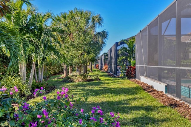 8089 Sandstar Way, Sarasota, FL 34240 - view of green lawn featuring a lanai