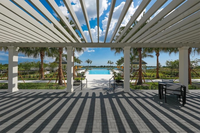 8089 Sandstar Way, Sarasota, FL 34240 - view of patio / terrace featuring a pergola and an outdoor pool