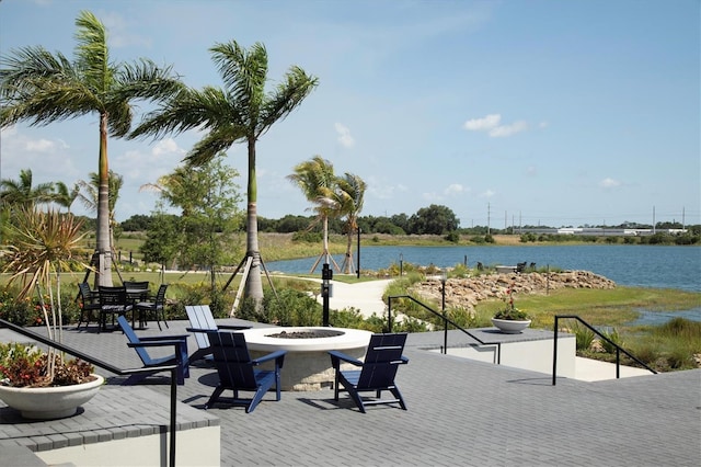8089 Sandstar Way, Sarasota, FL 34240 - view of patio / terrace featuring an outdoor fire pit and a water view