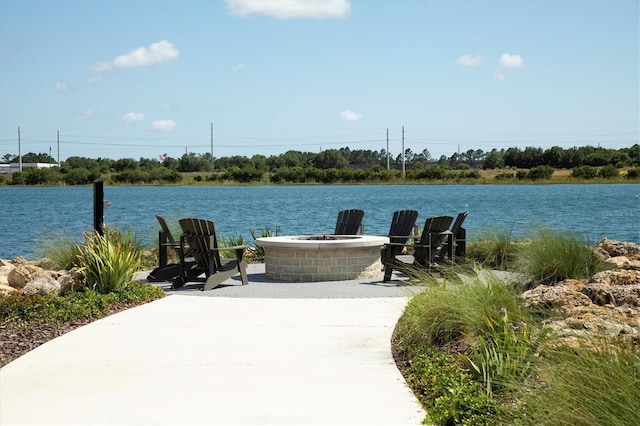 view of patio / terrace with a water view and an outdoor fire pit