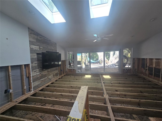 interior space featuring ceiling fan and vaulted ceiling with skylight