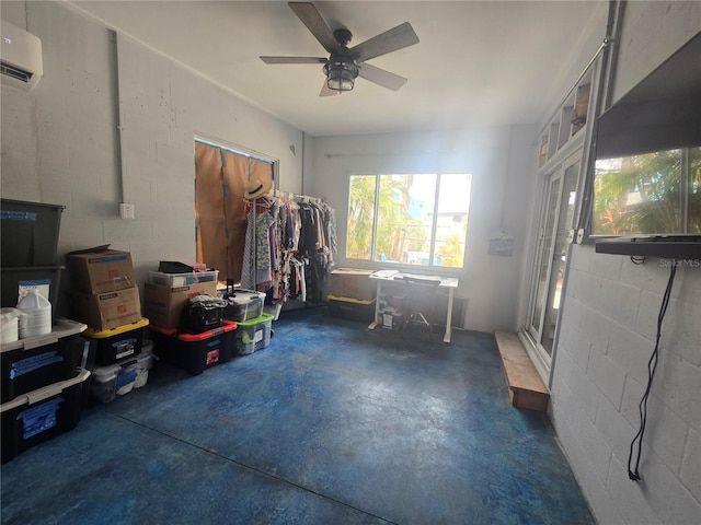 interior space featuring ceiling fan and a wall mounted AC