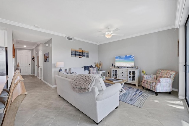 tiled living room with ceiling fan and crown molding