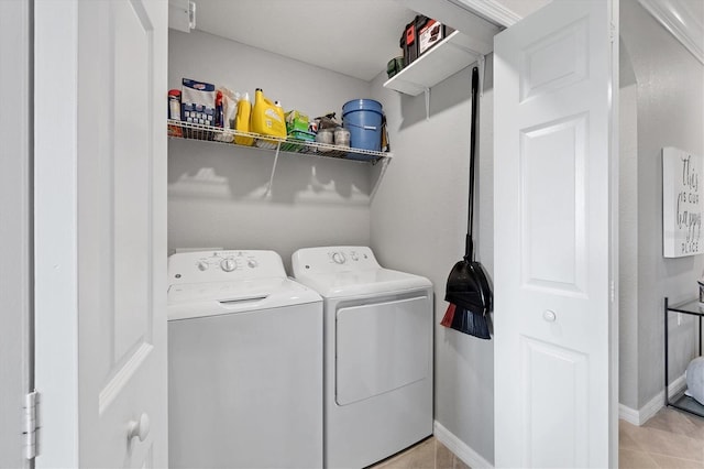 washroom featuring separate washer and dryer and light tile patterned floors