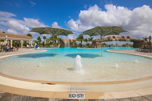 view of pool with pool water feature