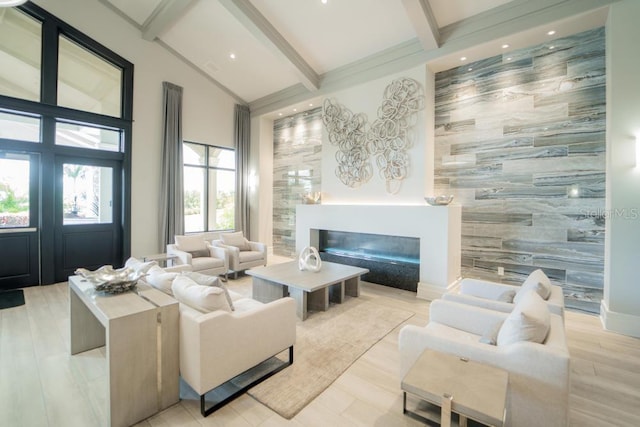 living room featuring lofted ceiling with beams, light hardwood / wood-style flooring, and tile walls