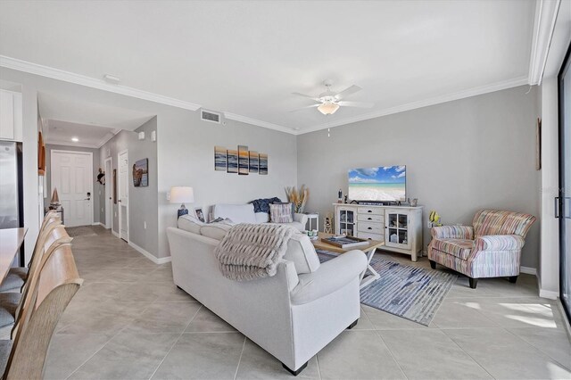 living area featuring a ceiling fan, crown molding, light tile patterned floors, baseboards, and recessed lighting