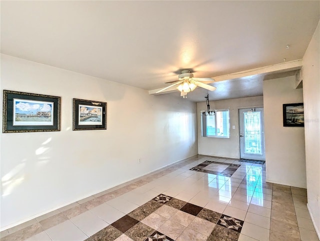 interior space featuring ceiling fan with notable chandelier