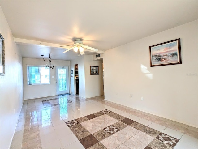 unfurnished room featuring ceiling fan with notable chandelier