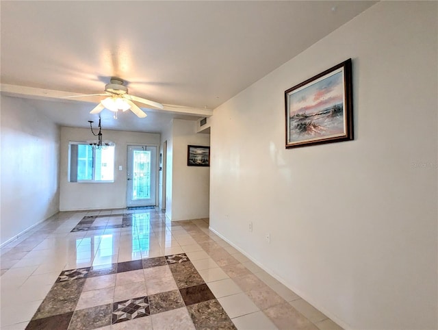 tiled spare room featuring ceiling fan