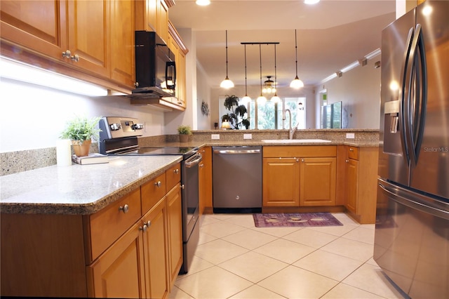 kitchen with pendant lighting, sink, light tile patterned flooring, kitchen peninsula, and stainless steel appliances