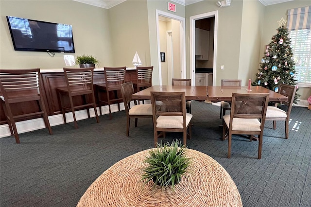 dining room featuring carpet floors and ornamental molding