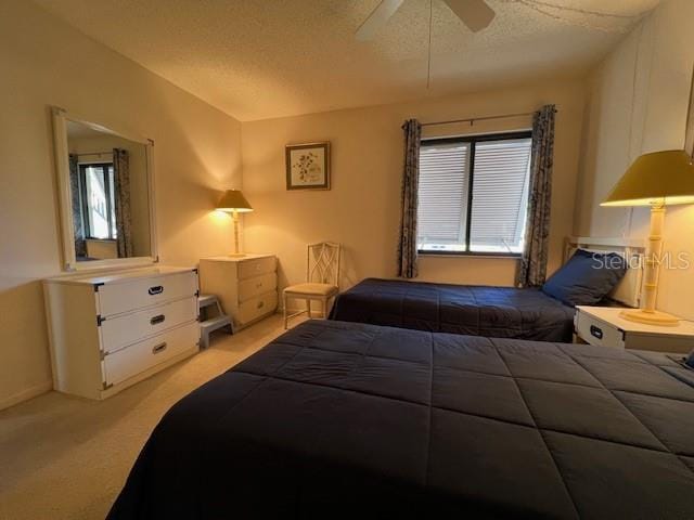 5171 Willow Links Unit 23, Sarasota, FL 34235 - bedroom featuring carpet floors, multiple windows, a ceiling fan, and a textured ceiling