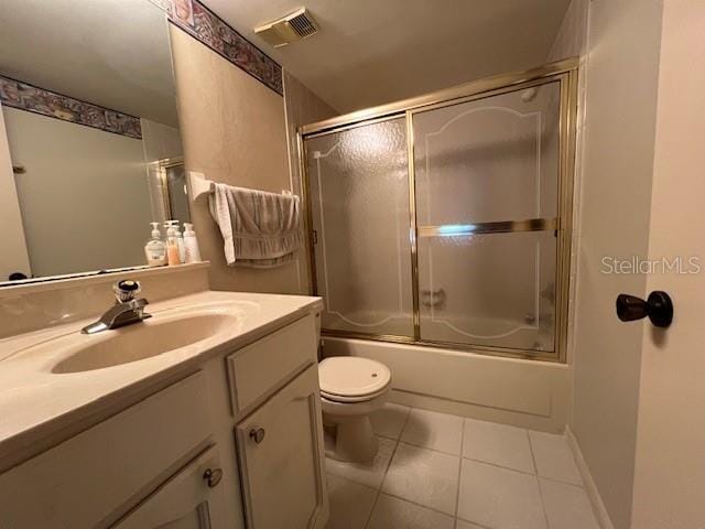 5171 Willow Links Unit 23, Sarasota, FL 34235 - bathroom featuring tile patterned flooring, vanity, and combined bath / shower with glass door