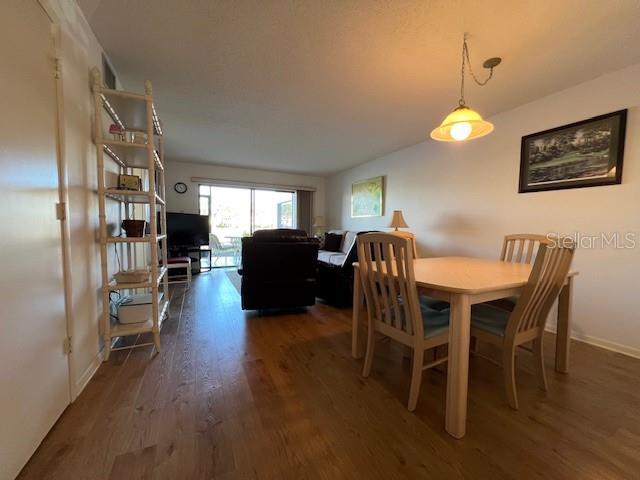 5171 Willow Links Unit 23, Sarasota, FL 34235 - dining area featuring wood finished floors and vaulted ceiling