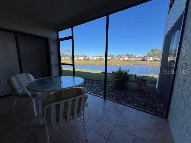 sunroom / solarium with a water view