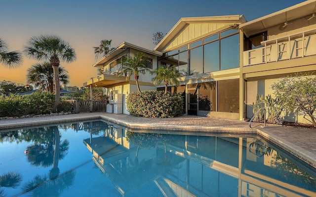 view of pool at dusk