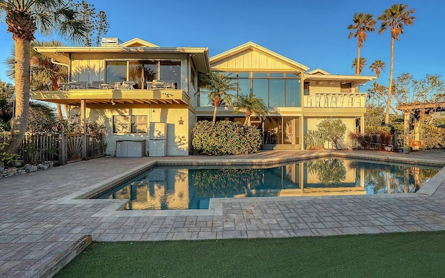 back of property with a patio and a balcony