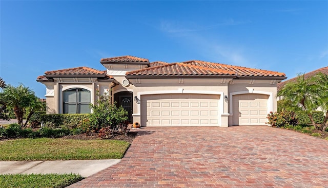 mediterranean / spanish home featuring a garage