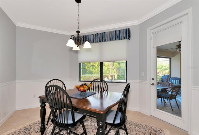 dining area with light tile patterned floors, ceiling fan with notable chandelier, a wealth of natural light, and crown molding