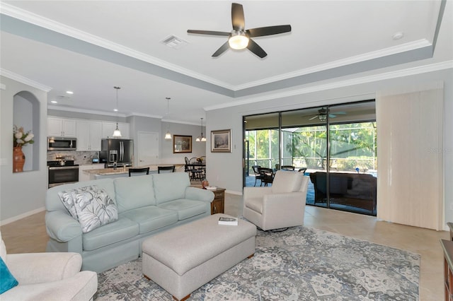 living room featuring light tile patterned floors, ceiling fan, and ornamental molding