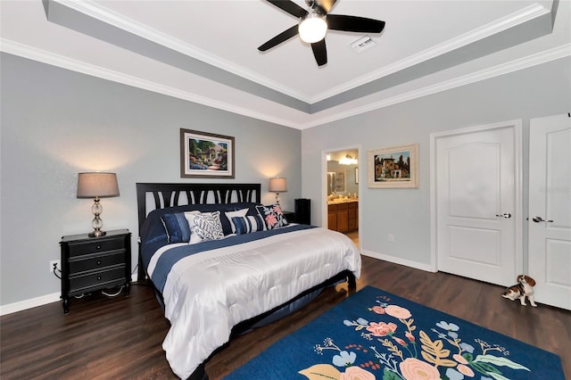 bedroom featuring dark hardwood / wood-style flooring, ensuite bath, ceiling fan, and ornamental molding