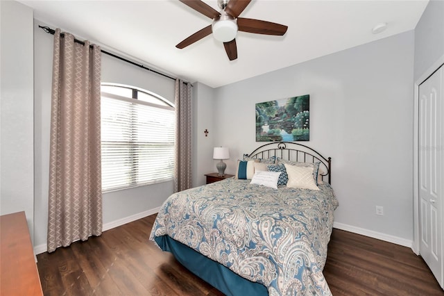 bedroom with ceiling fan, a closet, and dark wood-type flooring