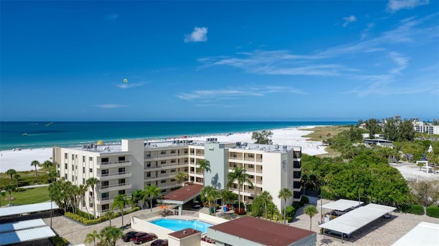 aerial view with a water view and a beach view