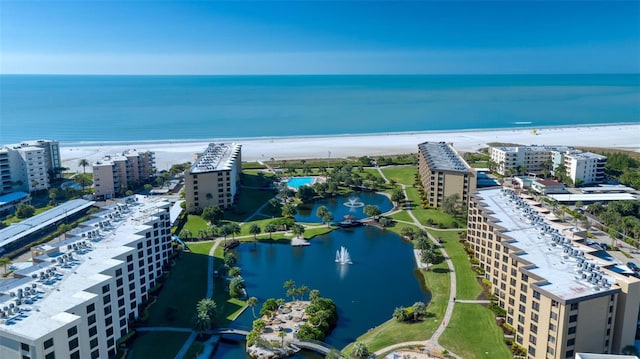 bird's eye view with a water view and a view of the beach