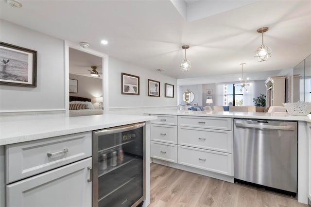 kitchen featuring white cabinetry, ceiling fan, hanging light fixtures, wine cooler, and stainless steel dishwasher