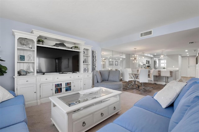 living room featuring an inviting chandelier and light wood-type flooring