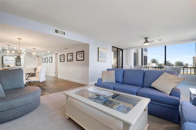 living room featuring hardwood / wood-style floors and ceiling fan