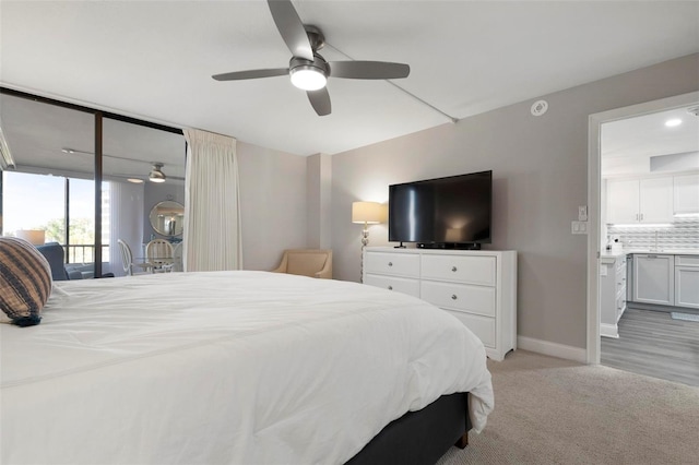 bedroom with access to outside, ceiling fan, and light colored carpet