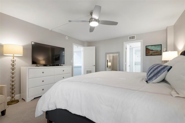 carpeted bedroom featuring ensuite bath and ceiling fan