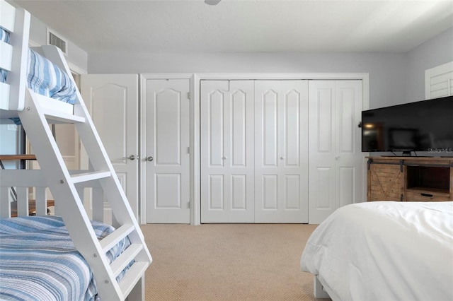 bedroom with light colored carpet