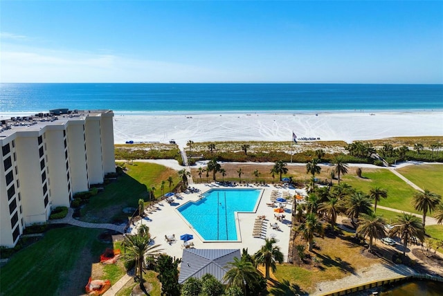 drone / aerial view featuring a beach view and a water view